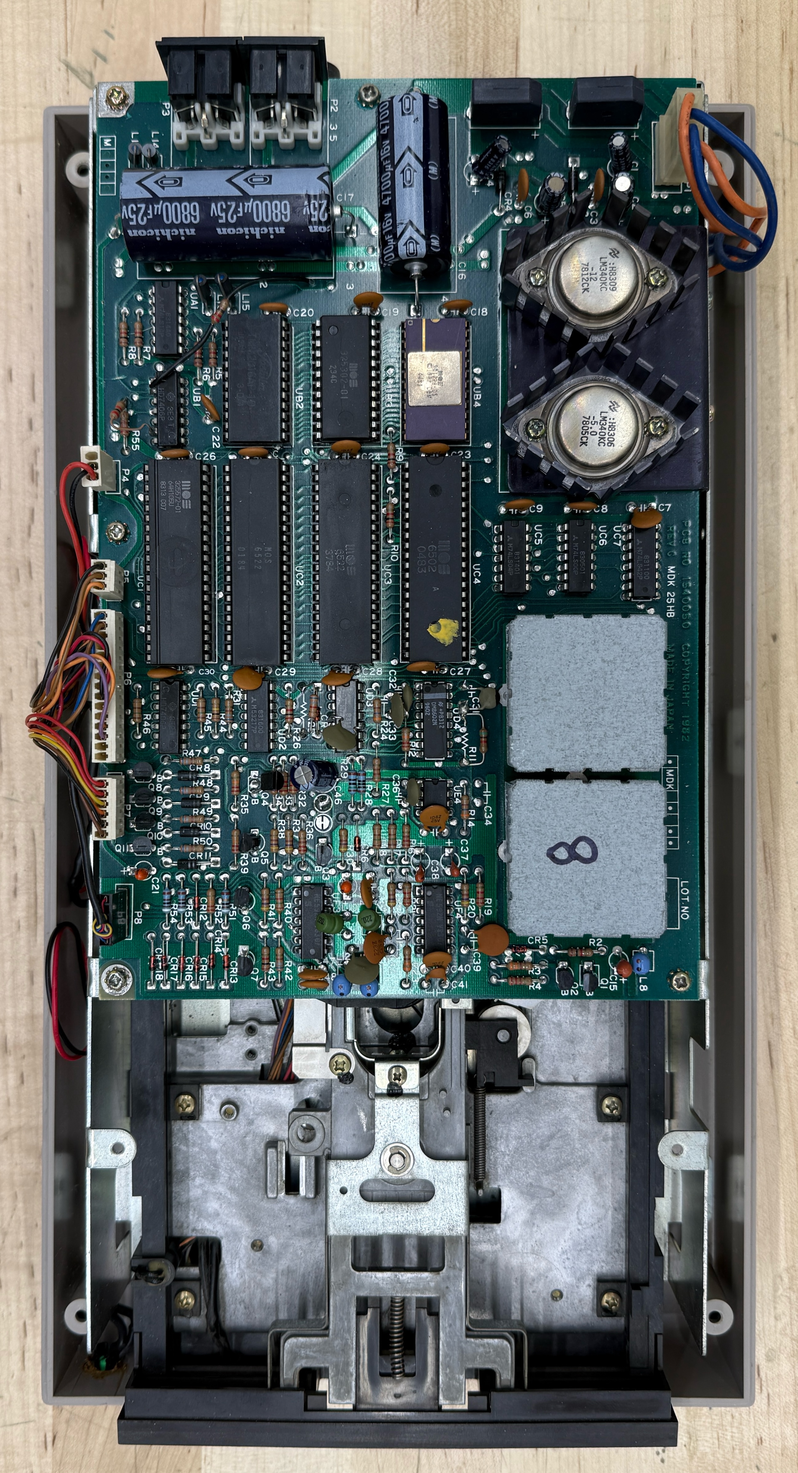 The same 1541 with the case opened, showing the controller PCB on top and the ALPS read/write mechanism below