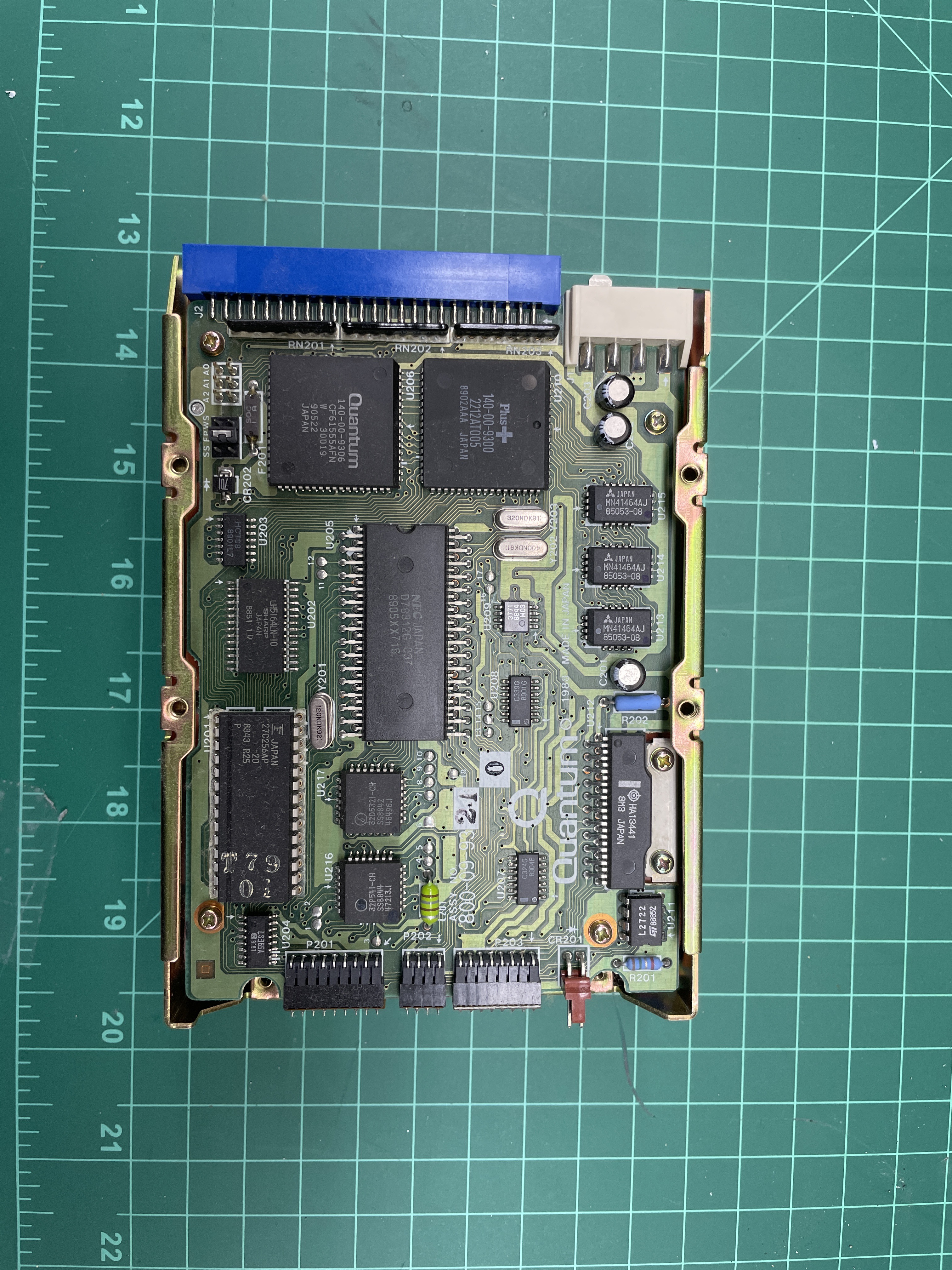 A small replacement printed circuit board on a cutting mat