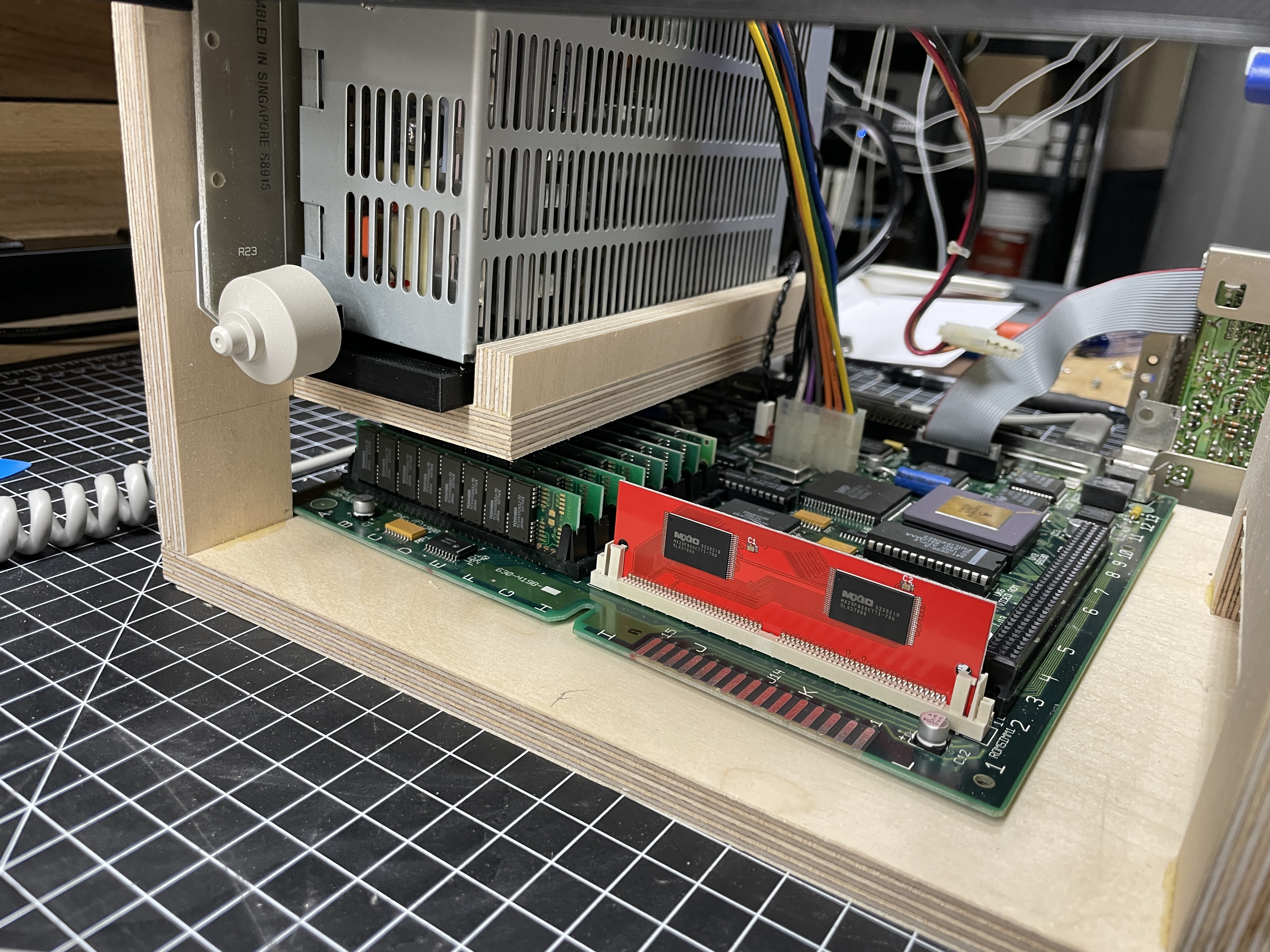 Inside view of the SE/30 chassis with the new power supply installed at the top and the ZuluSCSI 2040 board in the disk bay below