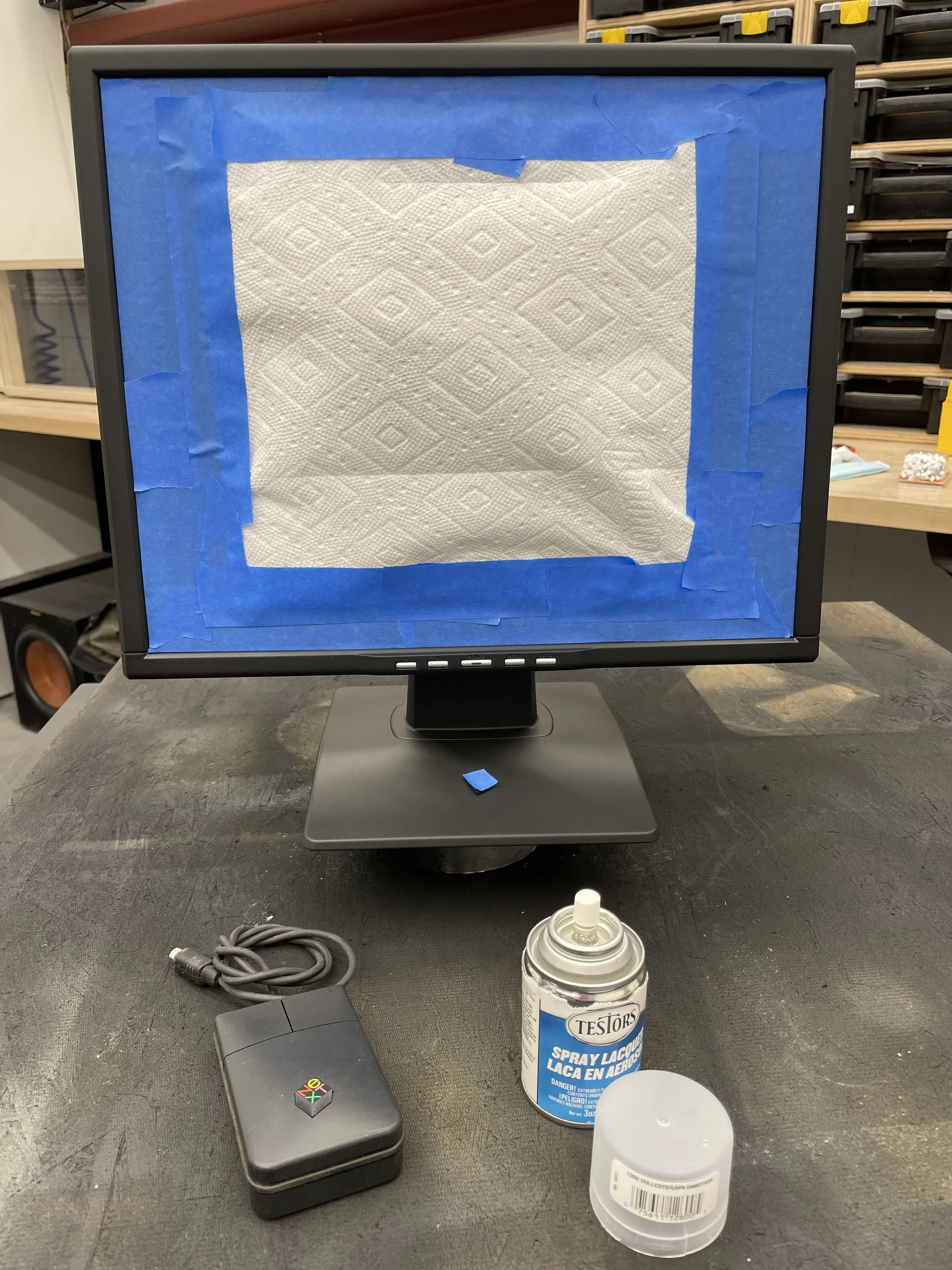Paint-prep masking with paper towel taped over the screen, the donor NeXT mouse, and a can of Testor&rsquo;s Dull Coat staged below